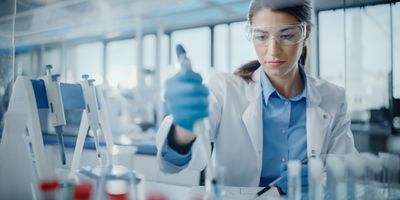 Female scientist using pipette in the lab