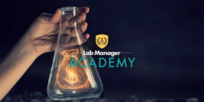 Scientist holds a beaker with a glowing money bag inside. Lab Manager Academy logo overlays the image.