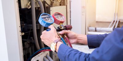 Technician checks pressure on a ULT freezer