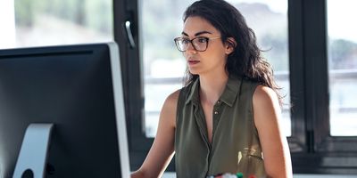 Shot of concentrated young business woman working with computer in the office.