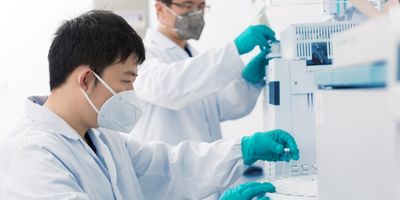 Two young researchers carrying out experiments in a lab