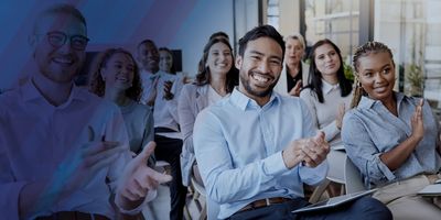 Group of diverse individuals sitting at a conference and applauding