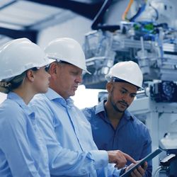 Engineers work on configuring a robot in a laboratory