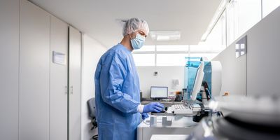 Latin American technician working at the laboratory analyzing blood samples