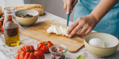 Womencutting cheese and preparing a healthy meal