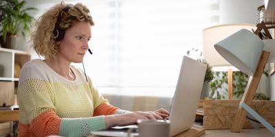 Caucasian woman, working from her modern home office