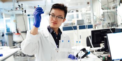 A scientist with NMR equipment behind them