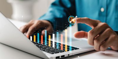 Man views metric charts on a laptop