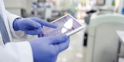 Scientist checks inventory on a tablet