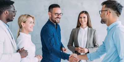 A lab manager shakes hands with a vendor