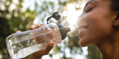 Woman drinks from a water bottle