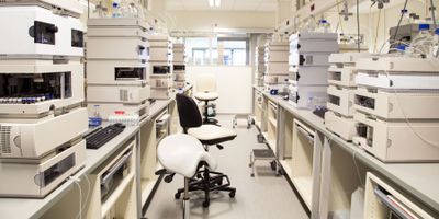 Two chairs between banks of analytical equipment