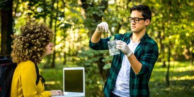 Two students collecting samples in nature