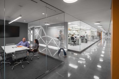 Interior shot of a research facility with a conference room adjacent to a laboratory.