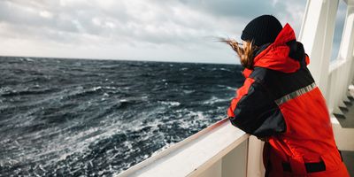 Woman researcher on a boat at sea in the arctic