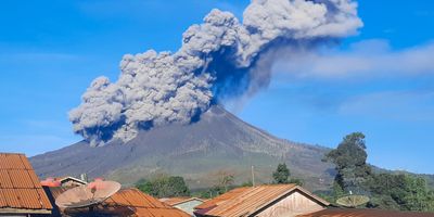 Erupting volcano spewing ash into the air