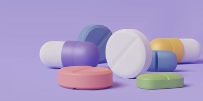 Computer image of several pills on a purple background