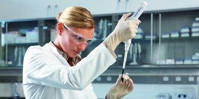 Woman researcher using Xplorer electronic pipette in the lab