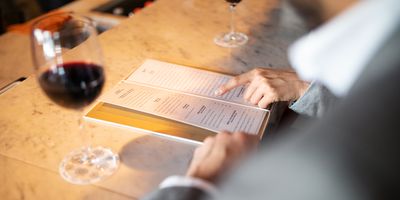 Person ordering off a menu at a restaurant 