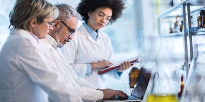 Three scientists working in a laboratory