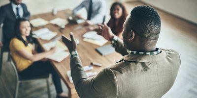 A leader running a meeting with coworkers 