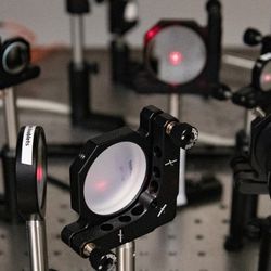 A series of mirrors and prisms deflect lasers and focus them to perform the reaction