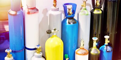 Gas cylinders sit in a corner of a laboratory