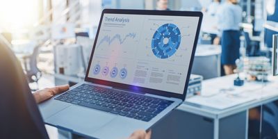 Scientist uses a computer with charts visualizing data on it