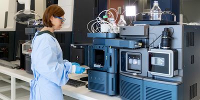 Female scientist working with a mass spec instrument in the lab