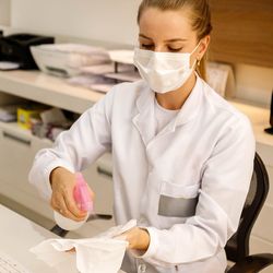 scientist cleaning bench and lab equipment