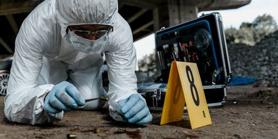 Forensic scientist collects a sample from a crime scene