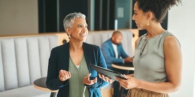 Two workers take part in a reverse mentorship meeting