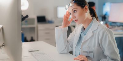 Lab manager looks at a computer in frustration