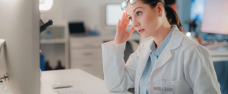 Lab manager looks at the computer in frustration