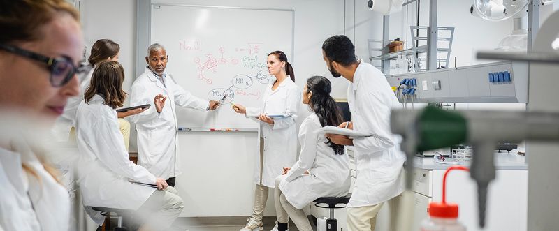 A group of seven scientists having a meeting