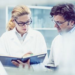 Two scientists review quality standards