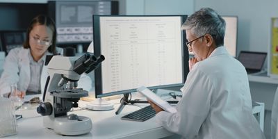 Female scientist analyzes data on a tablet