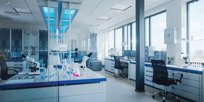 Wide shot of a clean, modern, organized laboratory with glass windows