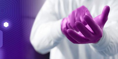 Close-up of lab staff pulling on purple Kimtech Polaris nitrile gloves