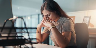 Women streesed out working in an office