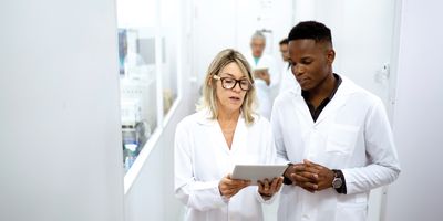 Two scientists use a tablet in the laboratory