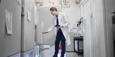 Scientist checks on samples in ULT freezer