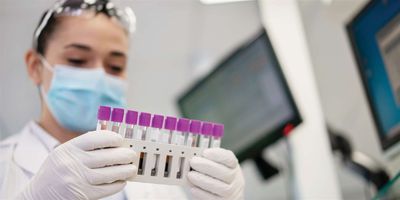 Scientist holding test tubes