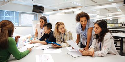 Lab planners hold a meeting around a conference table