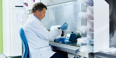 Scientist working in a fume hood