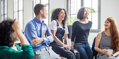 Professionals laughing in a meeting room