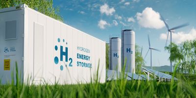 computer generated image of green energy solutions, featuring a large white shipping container labelled h2 energy storage, two white silos labelled H2, solar panels in the foreground, and wind turbines in the background all on green grass and in front of a blue sky with white clouds