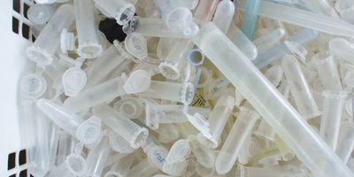 A bin full of plastic pipettes