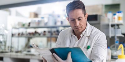 Researcher reading a journal article in the lab