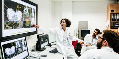 Researchers looking at data being presented digitlly on a screen